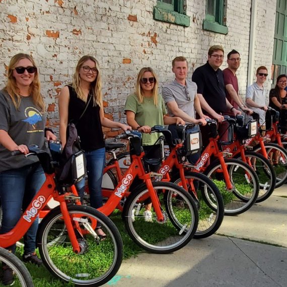 PEA interns riding MOGO bikes.