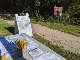 park trailhead with table, maps, and pencils asking for public input